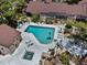 Aerial view of a community pool with blue water, surrounded by lounge chairs and lush greenery at 7705 4Th W Ave, Bradenton, FL 34209
