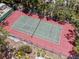 Aerial view of a well-maintained tennis court surrounded by trees at 7705 4Th W Ave, Bradenton, FL 34209