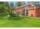 Expansive backyard features a covered patio, lush greenery, and an outdoor space perfect for relaxation and entertaining at 817 S West Shore Blvd, Tampa, FL 33609