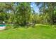 Secluded backyard features lush greenery, outdoor seating and a beautiful in-ground pool at 817 S West Shore Blvd, Tampa, FL 33609