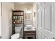 Compact bathroom features a vessel sink, tiled walls, and storage shelves for toiletries at 817 S West Shore Blvd, Tampa, FL 33609