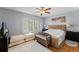 Cozy bedroom featuring hardwood floors, a neutral color scheme, and plantation shutters at 817 S West Shore Blvd, Tampa, FL 33609