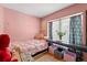 A view of a bedroom featuring pink walls, a window with curtains, and a bed at 817 S West Shore Blvd, Tampa, FL 33609