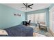 Bedroom features a window, ceiling fan, hardwood floors, a desk and chair at 817 S West Shore Blvd, Tampa, FL 33609