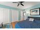Bedroom featuring a ceiling fan, wood floors, and two large closets at 817 S West Shore Blvd, Tampa, FL 33609