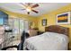 Yellow bedroom with hardwood floors, bright light, and ceiling fan at 817 S West Shore Blvd, Tampa, FL 33609