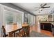Bright dining area with brick flooring, ceiling fan, and adjacent kitchen at 817 S West Shore Blvd, Tampa, FL 33609