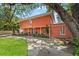 A stunning view of the two-story home showcasing the manicured lawn, mature trees, and spacious driveway at 817 S West Shore Blvd, Tampa, FL 33609