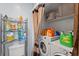 Laundry room features a washer, dryer, storage shelves, and cleaning products at 817 S West Shore Blvd, Tampa, FL 33609