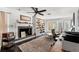 Bright living room boasts a fireplace with stone surround, built-in bookcase, and hardwood floors at 817 S West Shore Blvd, Tampa, FL 33609