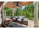 Covered patio with an outdoor ceiling fan and outdoor seating overlooking the pool and backyard at 817 S West Shore Blvd, Tampa, FL 33609