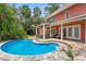 Backyard view with a pool, patio, and lush tropical landscaping around the yard at 817 S West Shore Blvd, Tampa, FL 33609