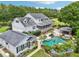 Stunning aerial view of a property with lush landscaping, a pool, and a separate guest house at 8410 Kenavis Pl, Odessa, FL 33556