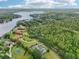 Breathtaking aerial view of an estate home nestled near a tranquil lake and surrounded by lush greenery at 8410 Kenavis Pl, Odessa, FL 33556
