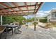 Backyard patio with outdoor dining and a lounge area near a luxurious pool and lush landscaping at 8410 Kenavis Pl, Odessa, FL 33556