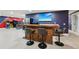 The bar area offers seating, wooden accents, a stainless steel refrigerator, and a view of arcade games at 8410 Kenavis Pl, Odessa, FL 33556