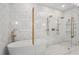 Luxurious bathroom featuring a glass walk-in shower and a soaking tub with lovely white marble mosaic tiling at 8410 Kenavis Pl, Odessa, FL 33556