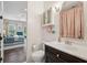 The charming bathroom features classic fixtures, a vanity with dark wood, and an adjacent bedroom at 8410 Kenavis Pl, Odessa, FL 33556
