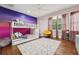 Comfortable bedroom with bunk beds, stylish decor, wood floors, and large windows at 8410 Kenavis Pl, Odessa, FL 33556