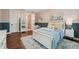 Charming bedroom featuring wainscoting, natural light, and ensuite bathroom, offering a comfortable and stylish space at 8410 Kenavis Pl, Odessa, FL 33556