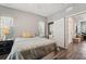 Cozy bedroom featuring a comfortable bed, stylish curtains, and closet with laundry at 8410 Kenavis Pl, Odessa, FL 33556