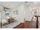 Dining area with a wooden table, cushioned bench seating, natural light, and hardwood floors at 8410 Kenavis Pl, Odessa, FL 33556