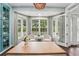 Sunlit dining room featuring bay windows, charming built-ins and stylish decor at 8410 Kenavis Pl, Odessa, FL 33556