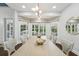 Airy dining room with large windows, stylish lighting, and comfortable seating offers an inviting atmosphere at 8410 Kenavis Pl, Odessa, FL 33556