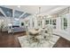 Bright dining area with coffered ceiling, ample seating, and open access to the living room and backyard at 8410 Kenavis Pl, Odessa, FL 33556