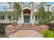 Elegant entryway with brick steps, covered entrance, and updated blue door at 8410 Kenavis Pl, Odessa, FL 33556