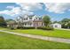 Charming two-story home with well-manicured lawn, brick accents, and a welcoming front porch at 8410 Kenavis Pl, Odessa, FL 33556