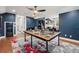A large game room with an elaborate table, decor, and a computer and desk in the background at 8410 Kenavis Pl, Odessa, FL 33556