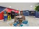 Game room with classic arcade games, a modern dining set, and stylish decor for leisure and entertainment at 8410 Kenavis Pl, Odessa, FL 33556