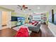 Bright game room with a TV, a couch, colorful rug, ample storage, and natural light from the window at 8410 Kenavis Pl, Odessa, FL 33556