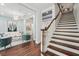 Hallway with staircase, hardwood floors, and entry to a living space at 8410 Kenavis Pl, Odessa, FL 33556
