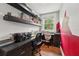 This home office features built-in shelving, a window offering natural light, and a desk with a swivel chair at 8410 Kenavis Pl, Odessa, FL 33556