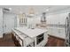 Bright open kitchen featuring a large center island with seating and modern appliances at 8410 Kenavis Pl, Odessa, FL 33556