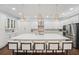 An immaculate kitchen with seating at the island, stainless appliances, and stylish pendants at 8410 Kenavis Pl, Odessa, FL 33556