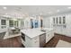 Bright kitchen offers an island with breakfast bar, stainless steel appliances, and seamless access to the dining area at 8410 Kenavis Pl, Odessa, FL 33556