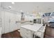 A gourmet kitchen with white cabinets, a quartz island, and designer pendant lighting at 8410 Kenavis Pl, Odessa, FL 33556