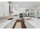 Beautiful kitchen showcases quartz counters, stainless appliances, breakfast bar, and seamless access to the living areas at 8410 Kenavis Pl, Odessa, FL 33556