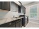 Updated laundry room complete with modern appliances, sink and plenty of cabinets at 8410 Kenavis Pl, Odessa, FL 33556