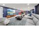 The living room features a large entertainment center, comfortable seating, and contemporary decor, ideal for relaxation at 8410 Kenavis Pl, Odessa, FL 33556