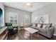 Cozy living room featuring plantation shutters, modern furniture, and stylish decor at 8410 Kenavis Pl, Odessa, FL 33556