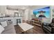 Open-concept living area with sleek decor, a breakfast bar, and comfortable seating at 8410 Kenavis Pl, Odessa, FL 33556