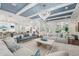 Expansive living room featuring coffered ceilings, a cozy seating area, and open layout perfect for entertaining at 8410 Kenavis Pl, Odessa, FL 33556