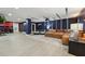 Spacious open-plan room, with red accent walls, houses a living room and game room area at 8410 Kenavis Pl, Odessa, FL 33556