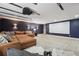 A comfortable movie room has a large screen, a projector, modern lights, and a plush sectional sofa at 8410 Kenavis Pl, Odessa, FL 33556