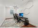 Brightly lit office space with two chairs, desks, and a unique hexagonal design on the wall at 8410 Kenavis Pl, Odessa, FL 33556