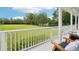 Inviting porch view showcasing outdoor seating and expansive green lawn at 8410 Kenavis Pl, Odessa, FL 33556